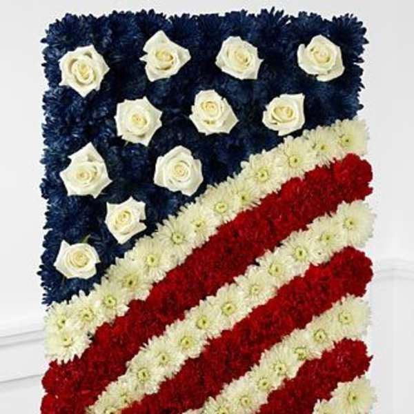 American flag floral tribute with red, white, and blue flowers