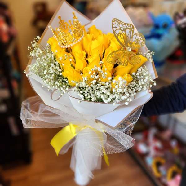 Yellow rose bouquet with baby’s breath and gold butterfly accents