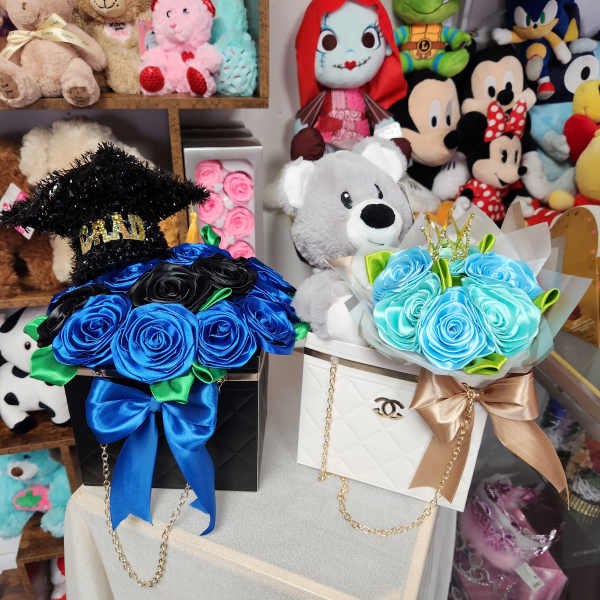 Two rose bouquets in gift boxes with teddy bears and ribbons