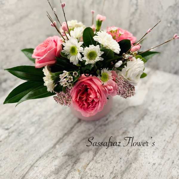 Pink and white flower arrangement in a small vase