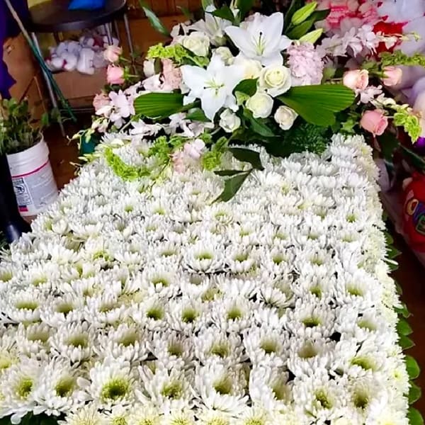 Large white chrysanthemum arrangement with lilies and pink accents