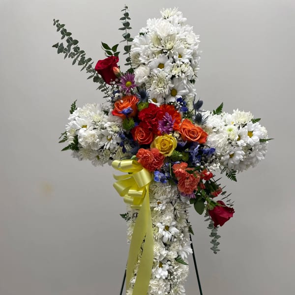 Cross-shaped floral standing spray with white daisies and colorful roses