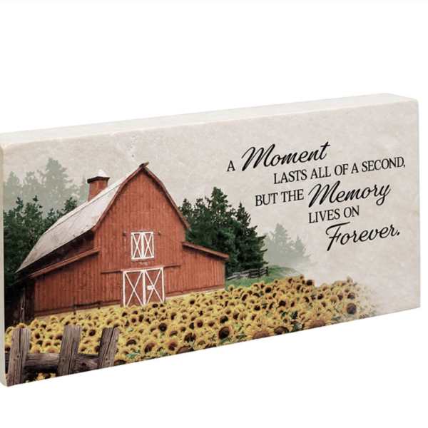Decorative memorial plaque with a barn, sunflowers, and a remembrance quote