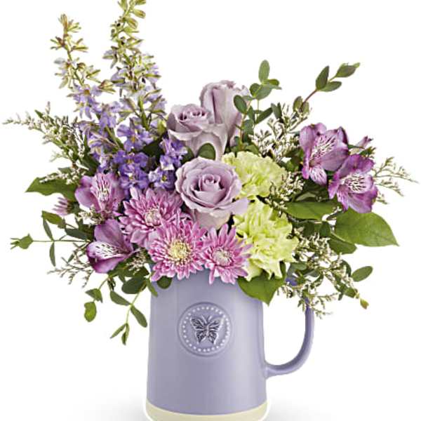 Lavender and pink bouquet in a purple pitcher vase