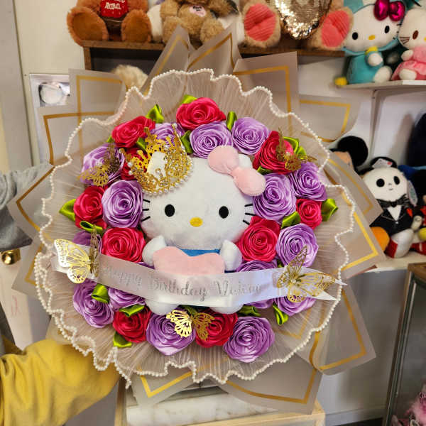 Hello Kitty plush bouquet with pink and purple roses and a birthday ribbon