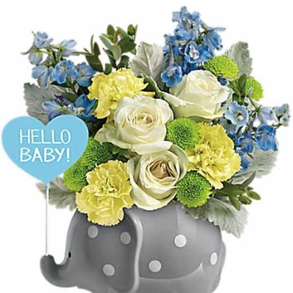 Blue and yellow flower arrangement in a gray elephant planter with a "Hello Baby!" sign