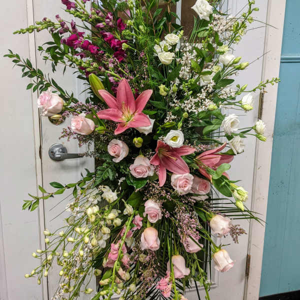 Tall floral standing spray with pink lilies, roses, and white blooms