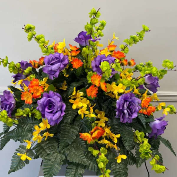 Colorful floral arrangement with purple, yellow, and orange blooms