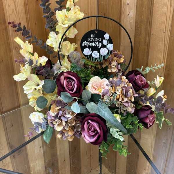 Floral sympathy wreath with roses and hydrangeas on a stand