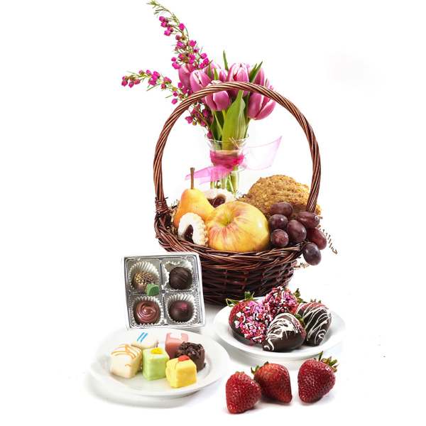 Gift basket with pink tulips and fruit, plus chocolates and strawberries
