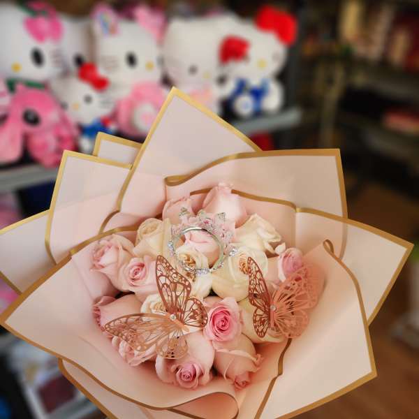 Bouquet of pale pink and cream roses with butterfly decorations