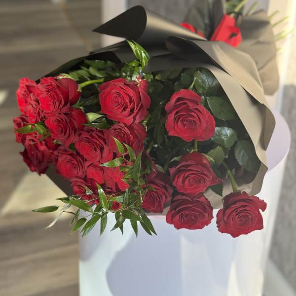 Bouquet of red roses wrapped in black paper
