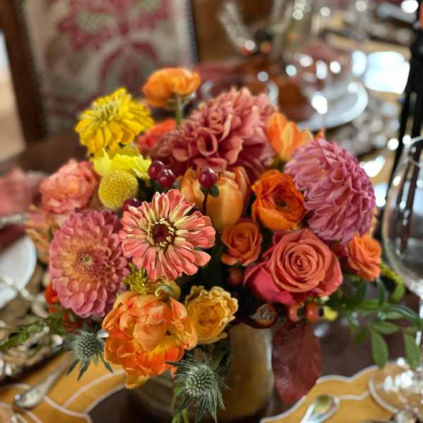 Colorful bouquet of roses, dahlias, and mums in a vase
