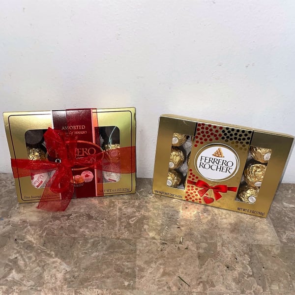 Two Ferrero Rocher chocolate gift boxes tied with red ribbon