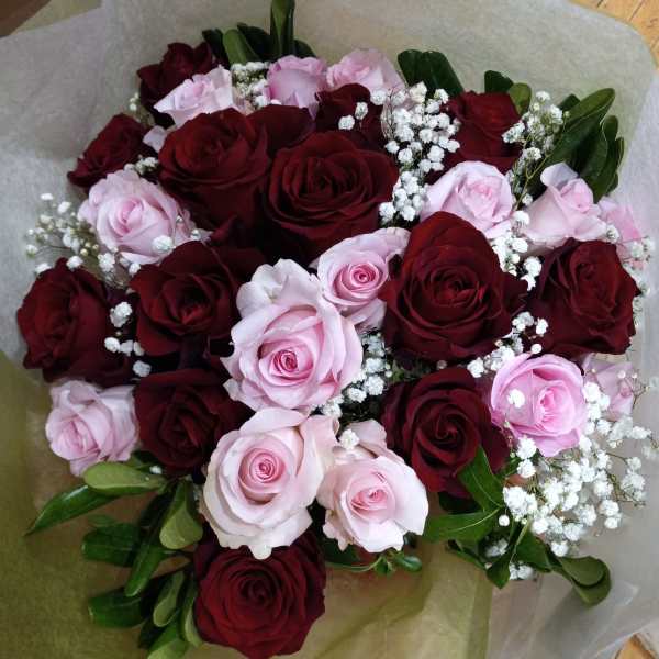 Bouquet of red and pale pink roses with white baby's breath