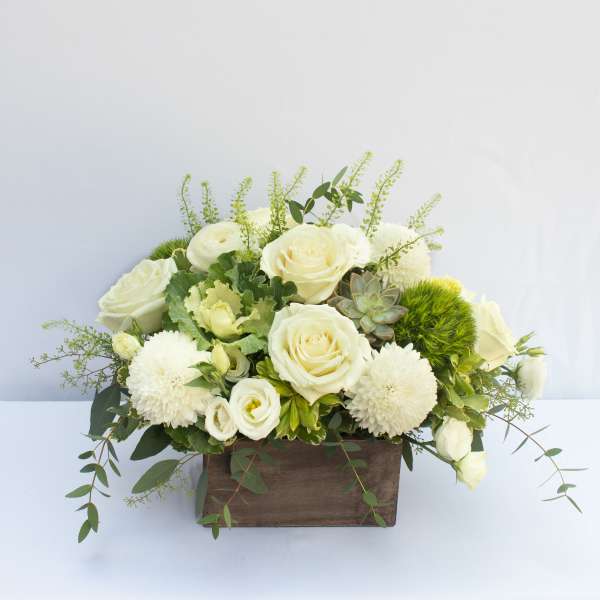 White roses and pompom blooms in a wooden box arrangement