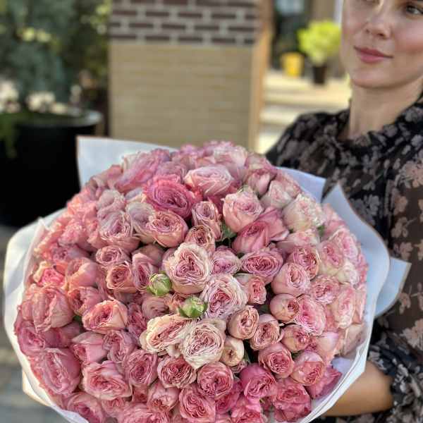 Large bouquet of pink roses wrapped in white paper
