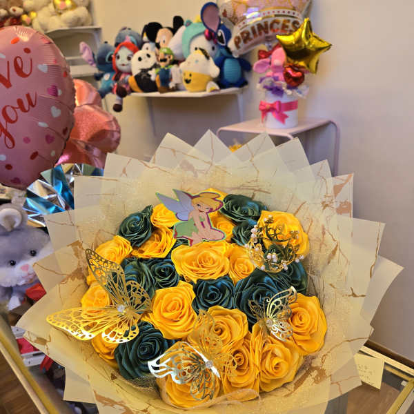 Bouquet of yellow and dark green roses with butterfly decorations