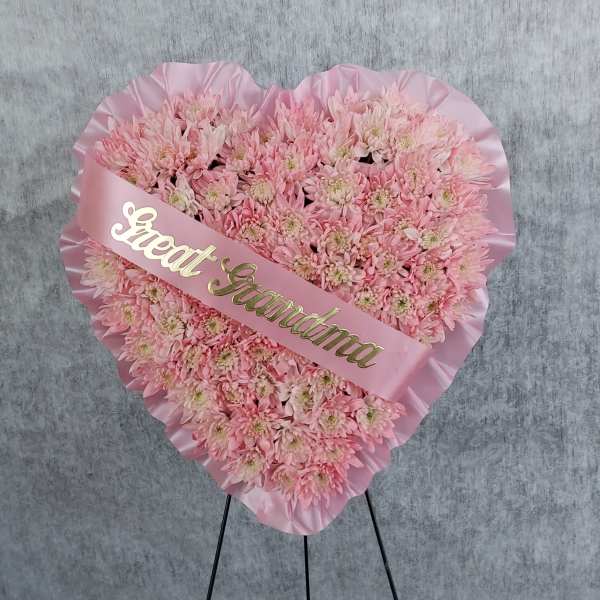 Heart-shaped pink chrysanthemum arrangement with a "Great Grandma" sash