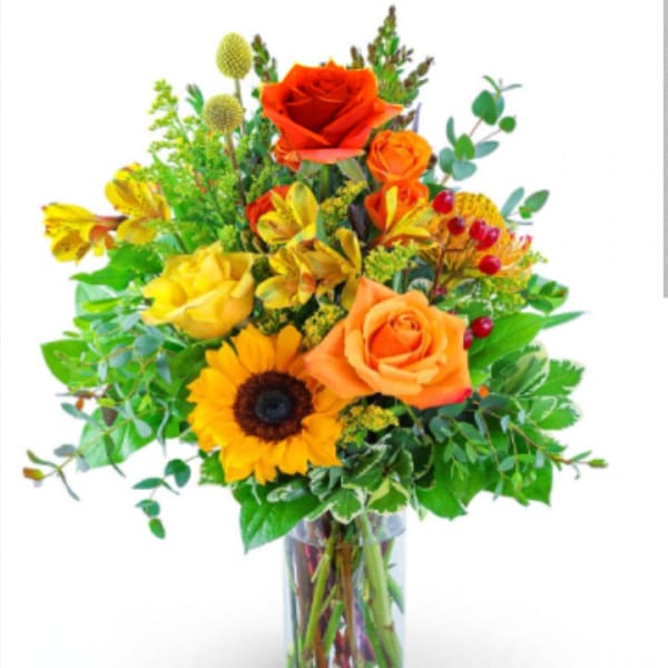 Bouquet of orange and yellow flowers in a clear glass vase