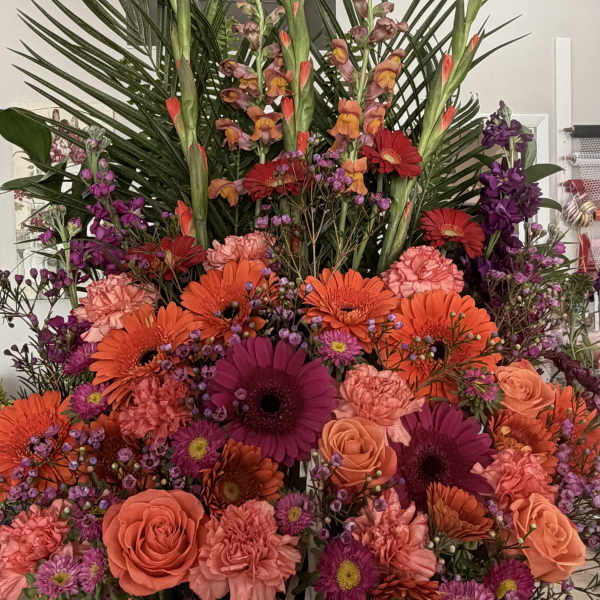 Large mixed flower basket with orange, pink, and purple blooms