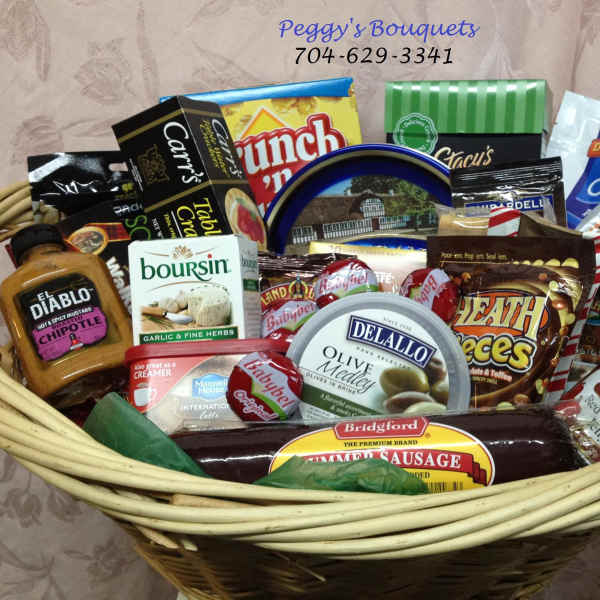Gift basket filled with assorted packaged snacks and condiments