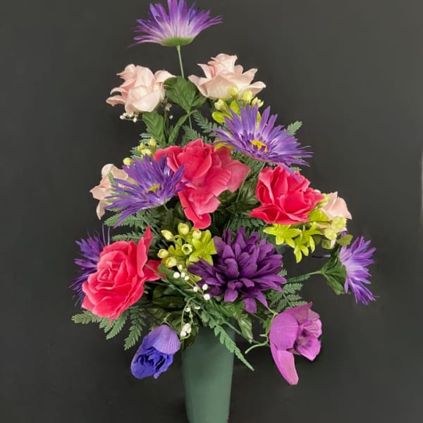 Colorful bouquet of mixed flowers in a green vase