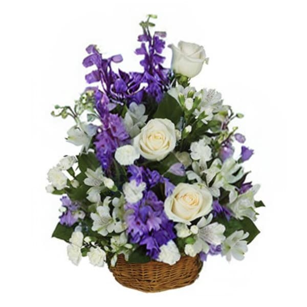 White roses and purple flowers in a wicker basket