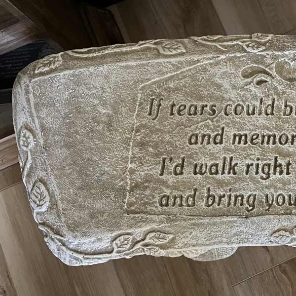 Stone memorial bench with engraved sympathy verse and heart detail