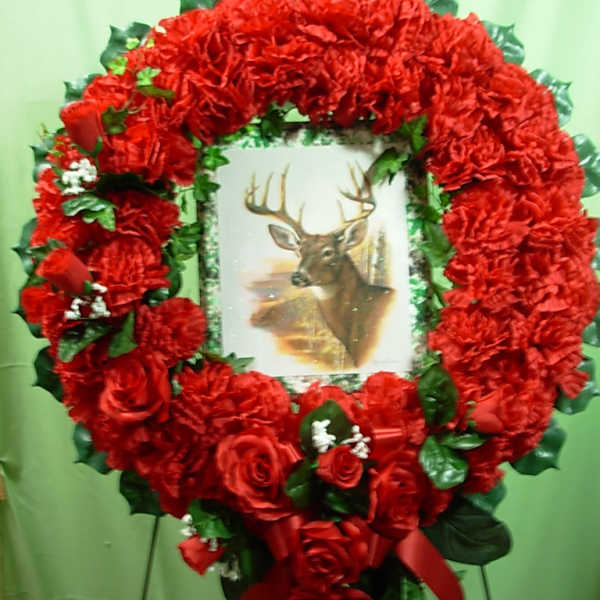 Heart-shaped red floral wreath with a deer picture in the center