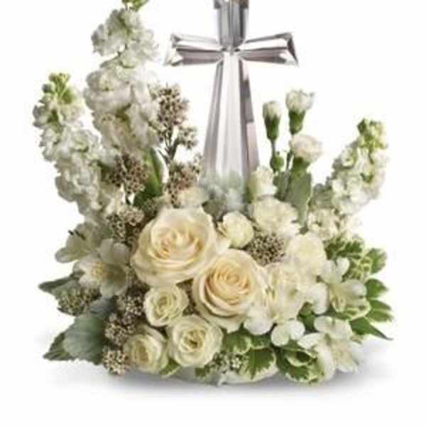 White floral arrangement with a silver cross centerpiece