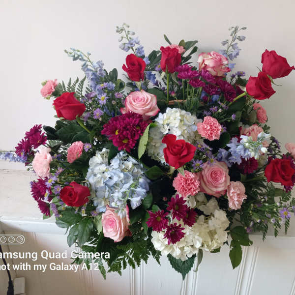 Mixed bouquet of red and pink roses with blue and white flowers