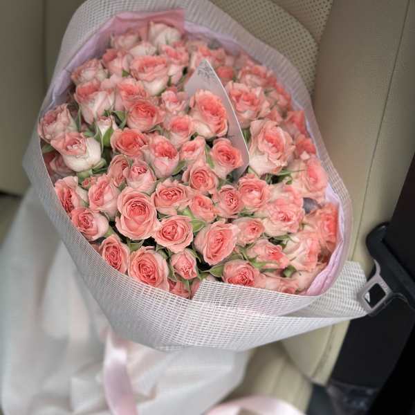 Bouquet of pink roses wrapped in pale pink paper