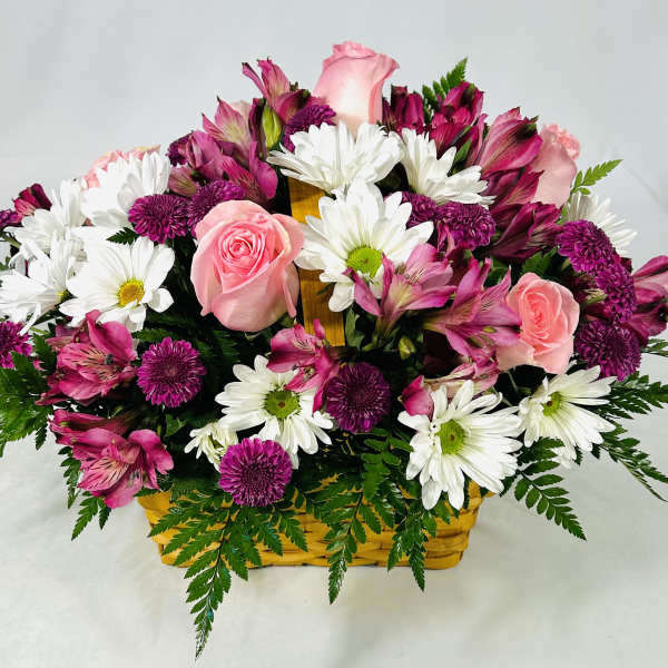 Basket arrangement of pink roses, purple mums, white daisies, and pink alstroemeria