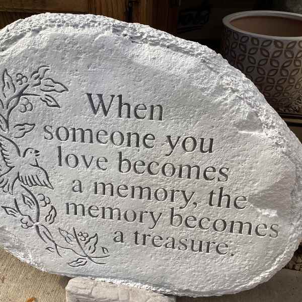 Engraved memorial stone with a dove and floral vine design