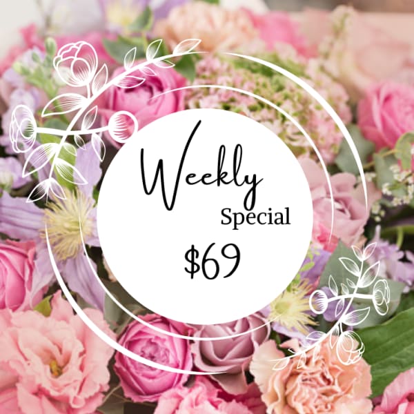 Pink and lavender flower bouquet with a "Weekly Special $69" sign