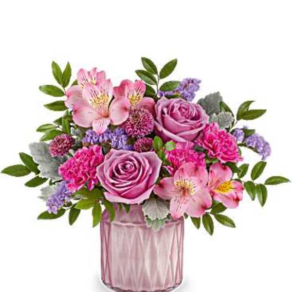 Pink and purple flower arrangement in a pink glass vase