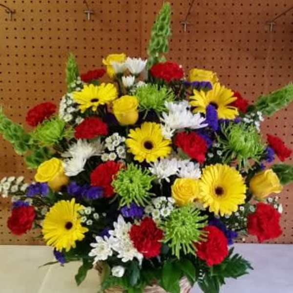 Bright Funeral Arrangment in Wicker