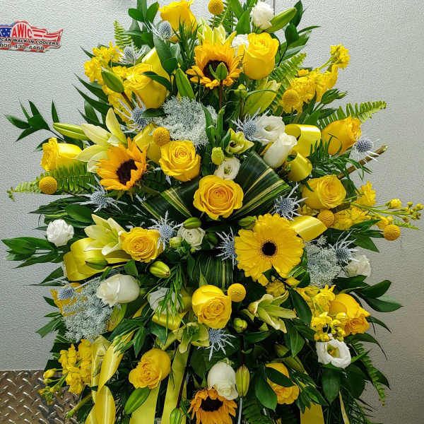 Large yellow and white floral standing spray with ribbons