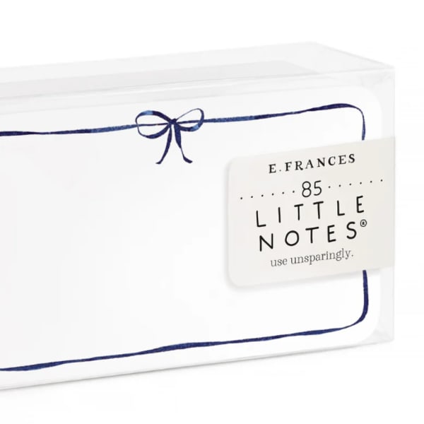Boxed set of white note cards with a navy border and bow