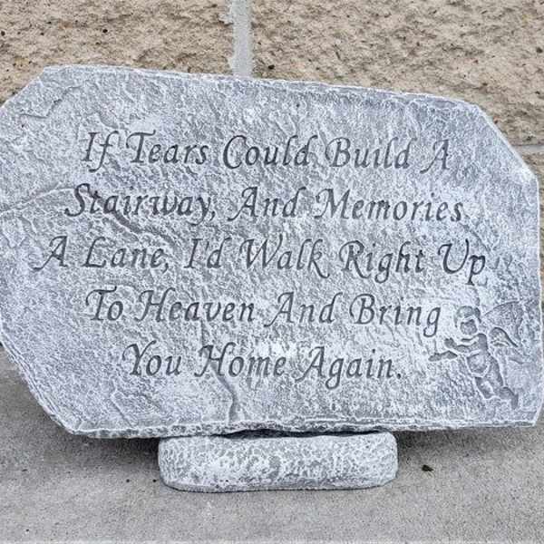 Engraved memorial stone with a poem on a stand