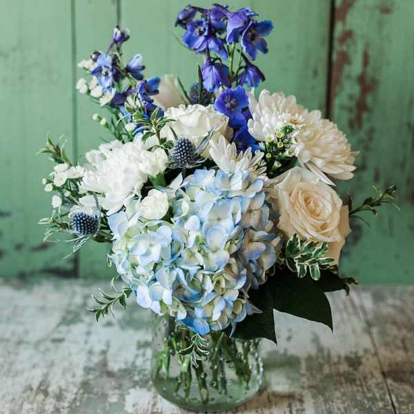 Blue and white bouquet in a clear glass vase