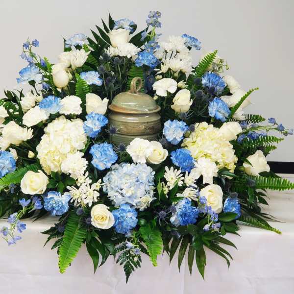 Blue and white floral arrangement with a decorative urn centerpiece