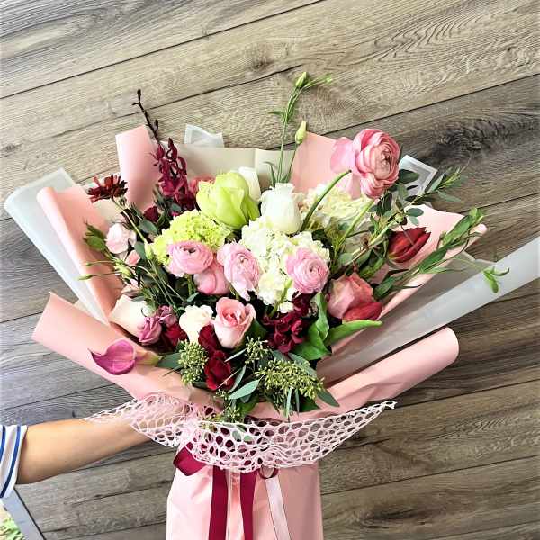 Pink and white mixed bouquet wrapped in pastel paper
