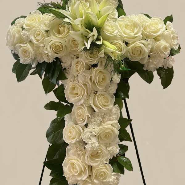 White rose and lily funeral spray on a standing easel