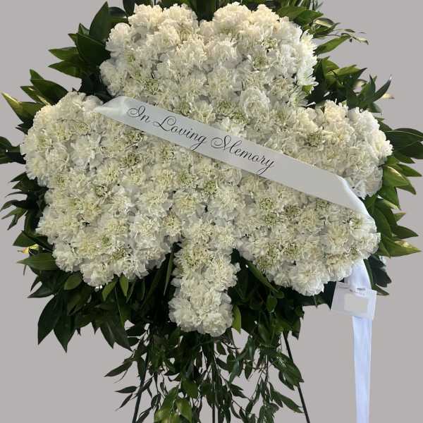 White funeral spray with an "In Loving Memory" ribbon