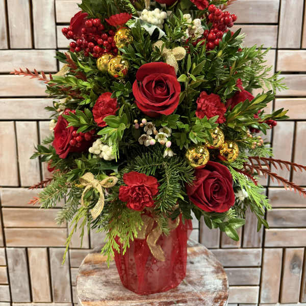 Red roses and carnations in a red vase with gold ornaments