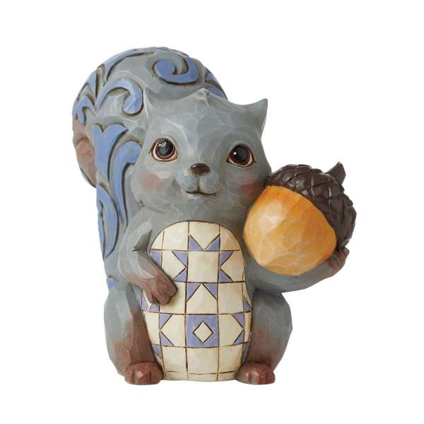 Decorative squirrel figurine holding an acorn
