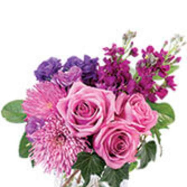Pink and purple mixed bouquet in a clear glass vase