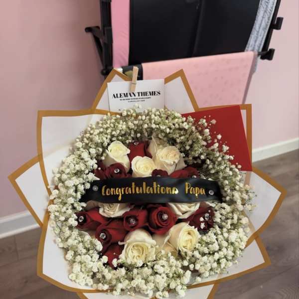 Red and white rose bouquet with baby's breath and a congratulatory ribbon